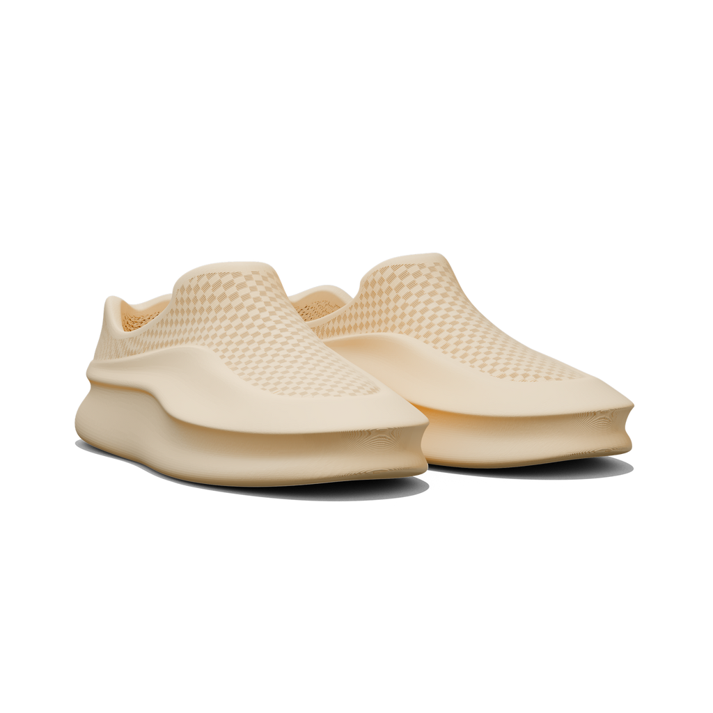 Pair of beige slip-on shoes on a white background